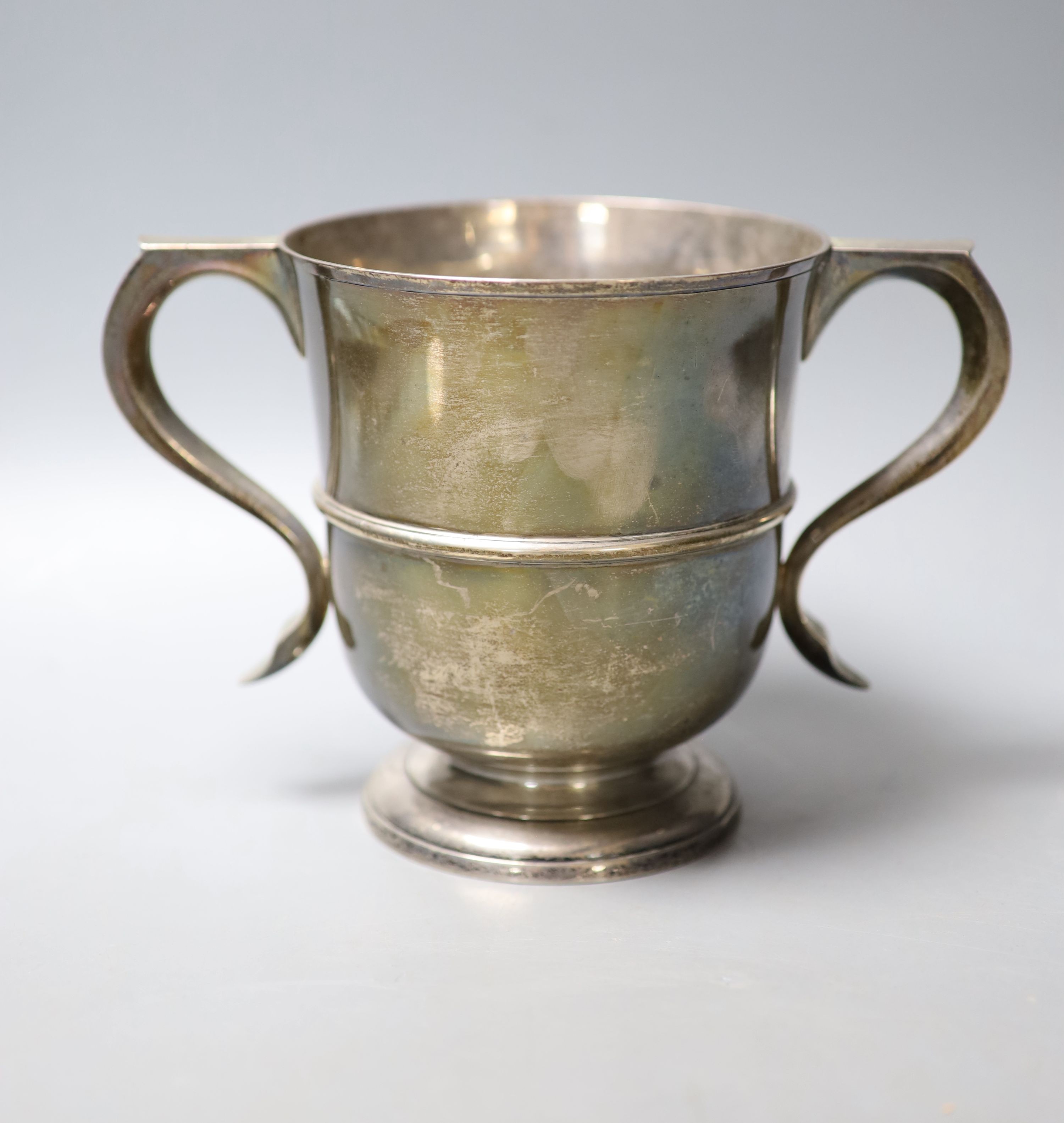An Edwardian silver two handled trophy cup, with banded girdle, Robert Dicker, London, 1904, height 14.4cm, 19.5oz.